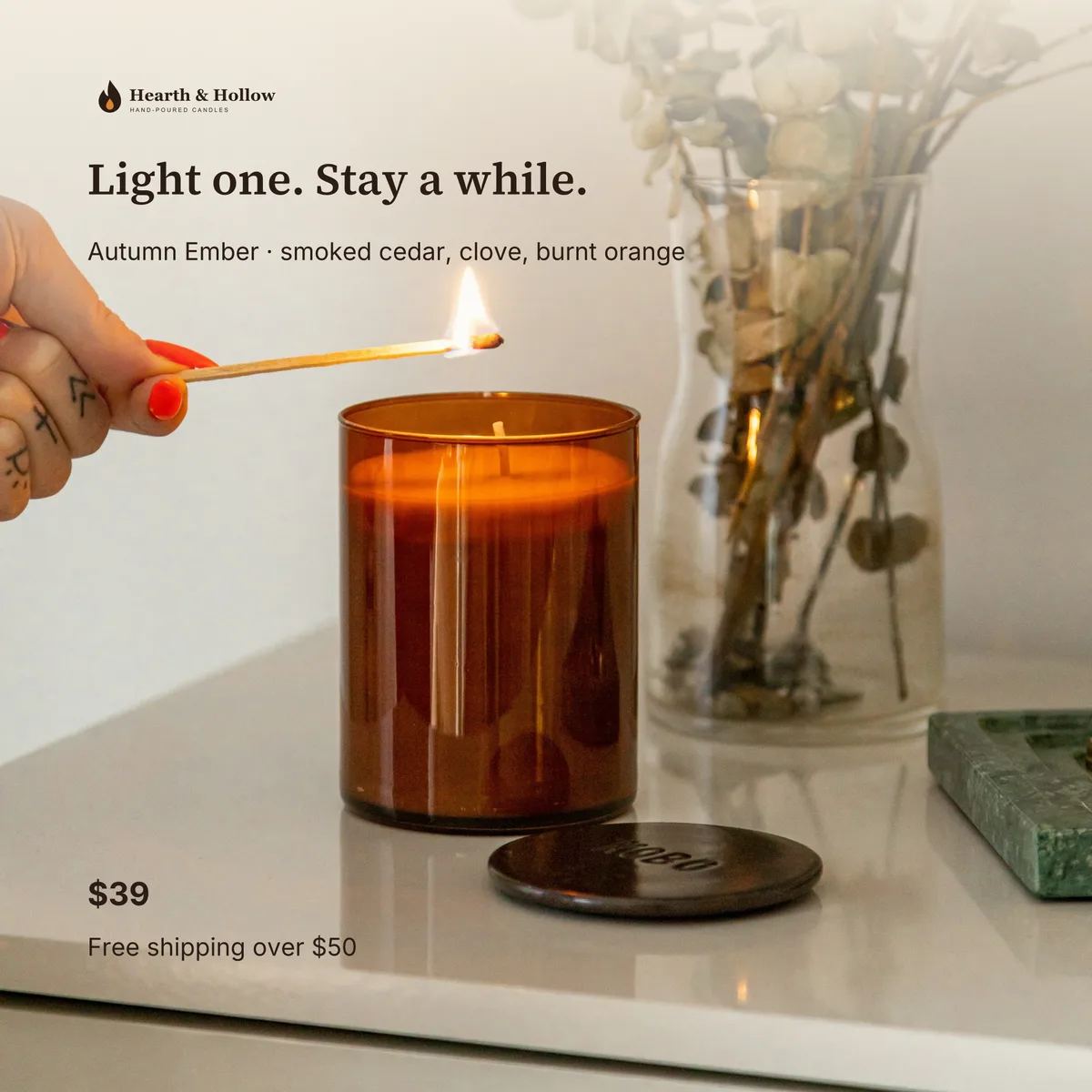 Shopify product image: the candle on a table with a match, $39 and free shipping over $50.